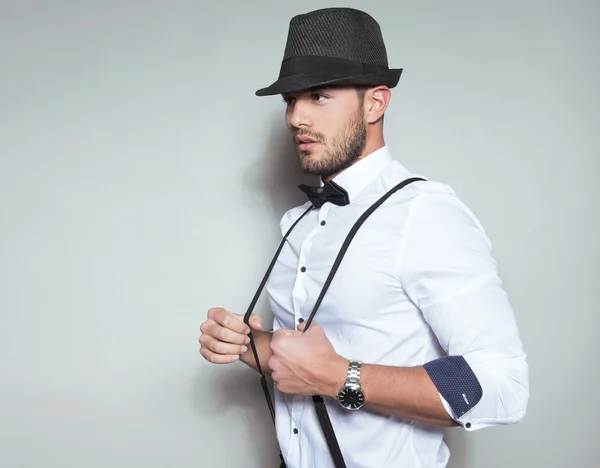 Handsome young man in suit on grey background — Stock Photo, Image