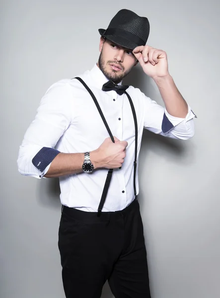 Handsome young man in suit on grey background Stock Picture