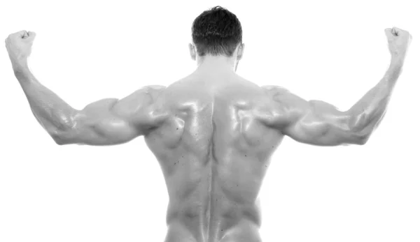 Bello giovane bodybuilder mostrando del suo corpo in forma e muscoli su sfondo isolato — Foto Stock