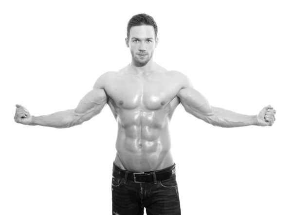 Handsome young bodybuilder showing of his fit body and muscles on isolated background — Stock Photo, Image