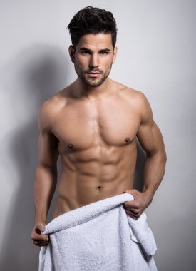 Onun kas gösterilen yakışıklı kaslı genç vücut geliştirmeci