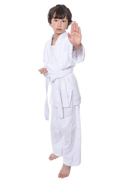 Young asian boy isolated on white in judo clothing doing martial arts — Stock Photo, Image