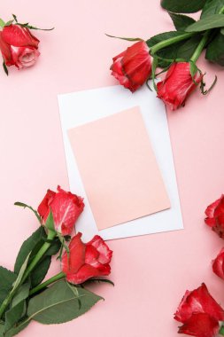 Sevgililer günü, doğum günü ya da yıldönümü kutlamaları için güzel ve şenlikli bir geçmiş. Kırmızı güller ve yazı için beyaz kalp şeklinde bir kart.