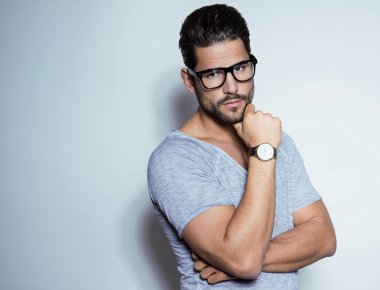 Yakışıklı genç adam günlük kıyafetlerle poz veriyor.