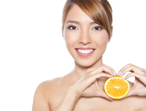 Beautiful young asian woman with long hair, flawless skin and perfect make-up, holding orange — Stock Photo, Image