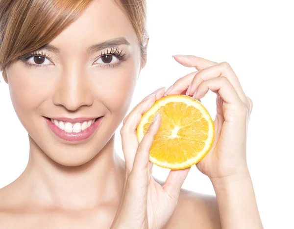 Beautiful young asian woman with long hair, flawless skin and perfect make-up, holding orange — Stock Photo, Image