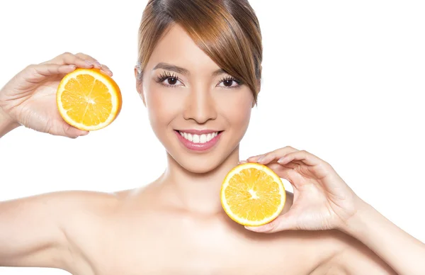 Beautiful young asian woman with long hair, flawless skin and perfect make-up, holding orange — Stock Photo, Image