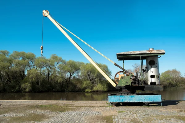 Crane on a riverside harbor — Stock Photo, Image