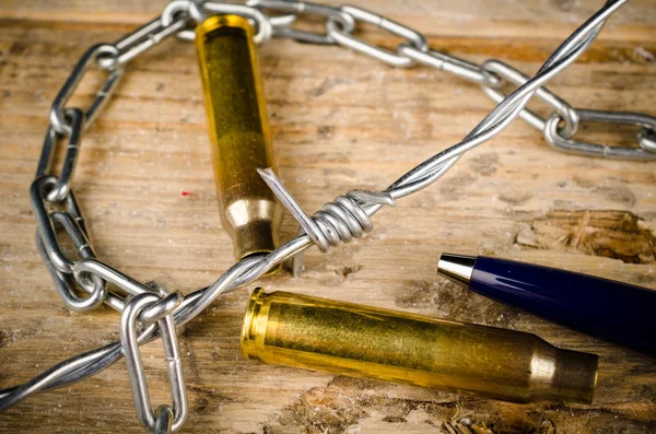 Bullets, pen and barbed wire — Stock Photo, Image