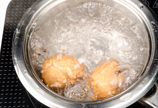 Eggs boiling in pan — Stock Photo, Image