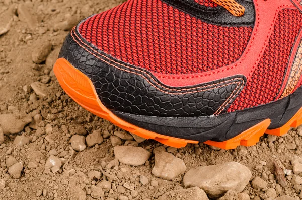 Sneaker on rough unpaved ground — Stock Photo, Image