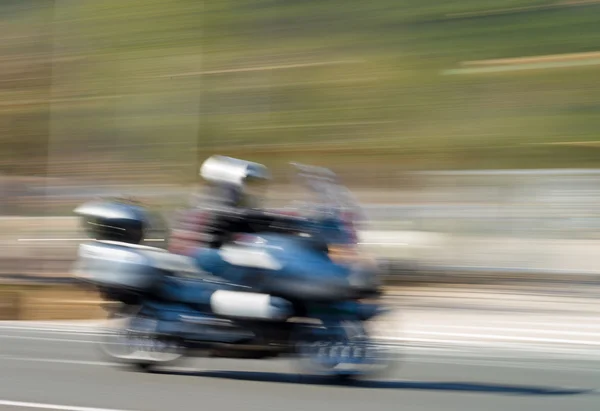 Speeding motorbike with motion blur — Stock Photo, Image
