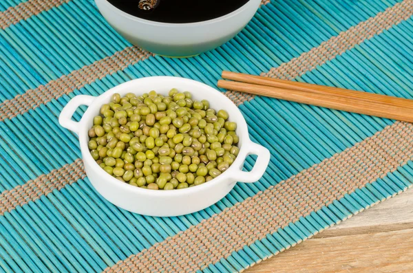 Soy sauce and soy beans — Stock Photo, Image