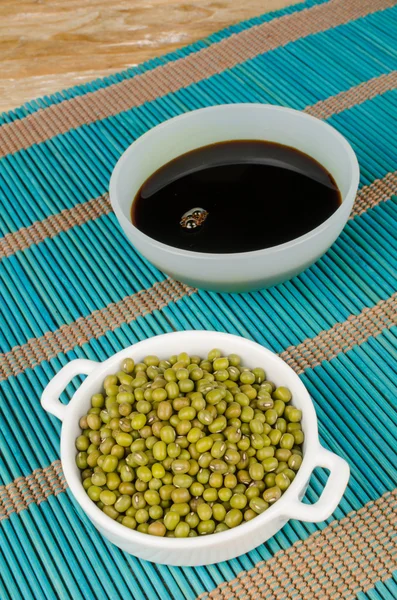 Bowls with soy sauce and soy beans — Stock Photo, Image