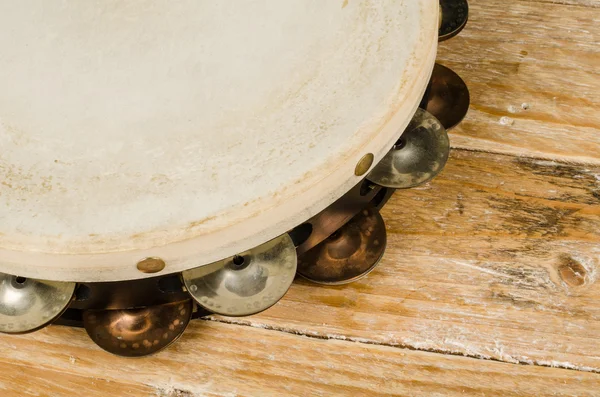 Tambourine on a wooden table — Zdjęcie stockowe
