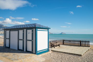 Toilet booth on beach clipart