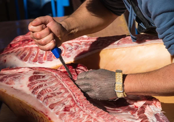 Butcher hands on fresh pork — Stock Photo, Image