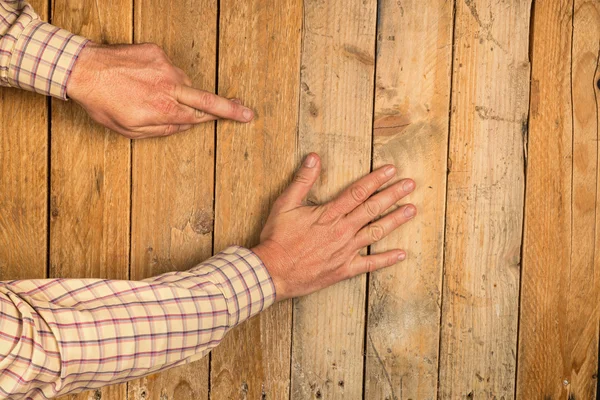 Human hand on wooden background — Stock Photo, Image