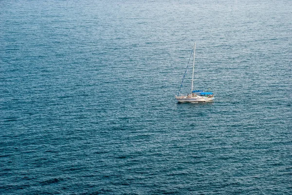 The yacht is isolated against the backdrop of the Black Sea waves.