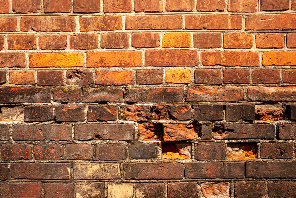 Texture and background from the wall of old red bricks.