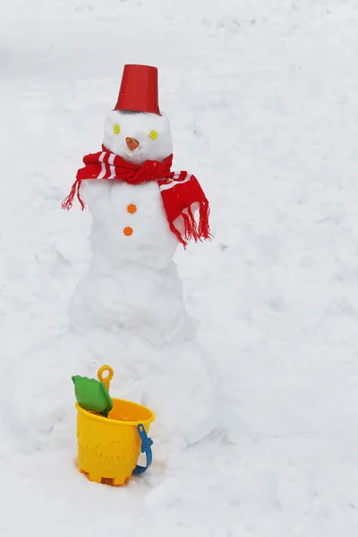 Snowman with red bucket — Stock Photo, Image