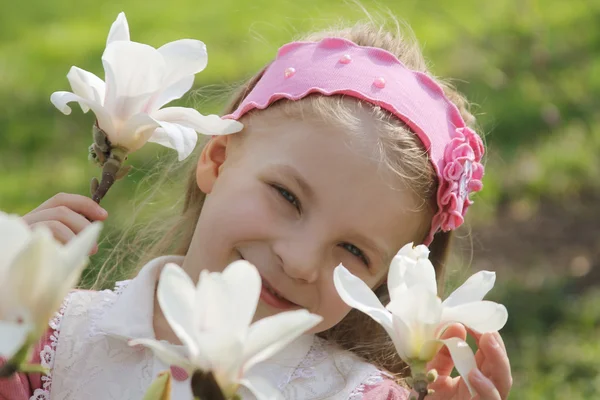 Girl with blooming magnolia flowers — Stock Photo, Image