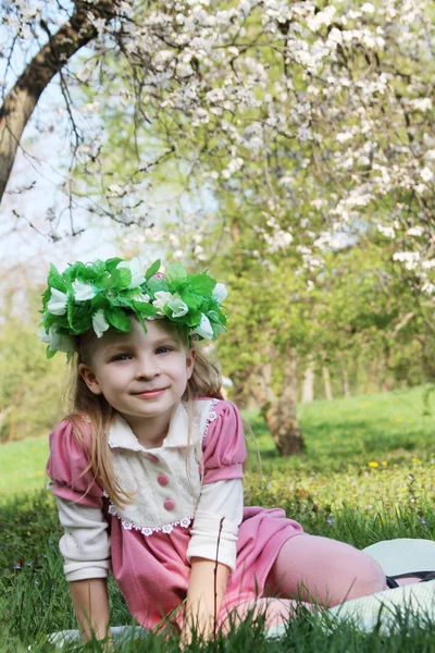 Smiling little girl with floral wreath — Stock Photo, Image