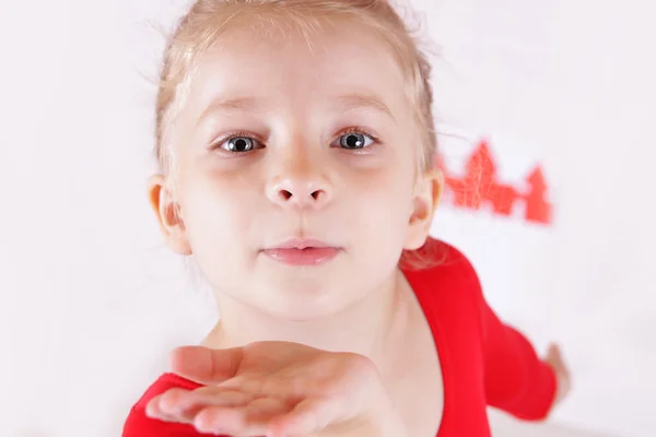 Cute girl in red sending kiss — Stock Photo, Image