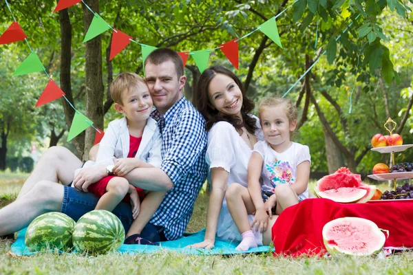 Family with two children on watermelon picnic — Stock Photo, Image