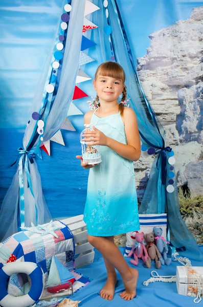 Girl in a blue dress on a background seascape — Stok fotoğraf