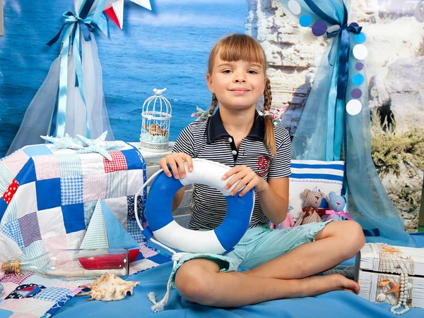 Girl in a striped shirt with a lifeline against a background sea — Stock Photo, Image