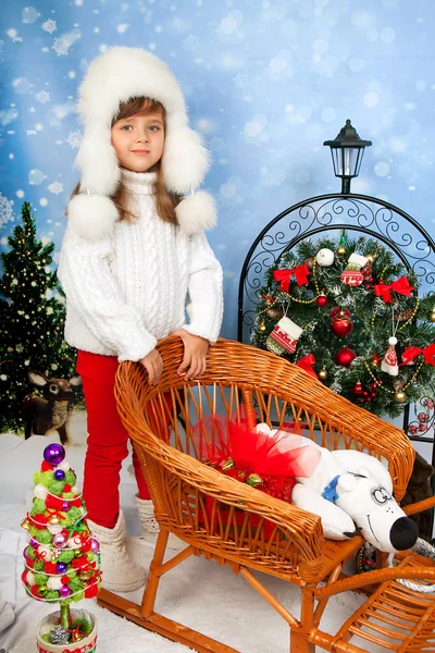 Beautiful girl in a white cap and knit sweater costs about wicke — Stock Photo, Image