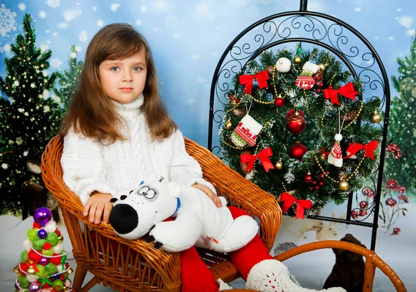 Beautiful little girl with long vollosami in knit sweater sittin — Stock Photo, Image