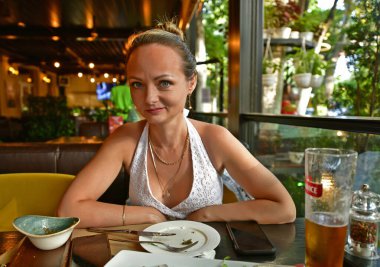 Genç ve güzel bir aile bir restoranda yemek yer..