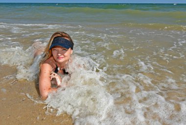 Karadeniz kıyısında mayo giymiş güzel bir kadın dinleniyor..