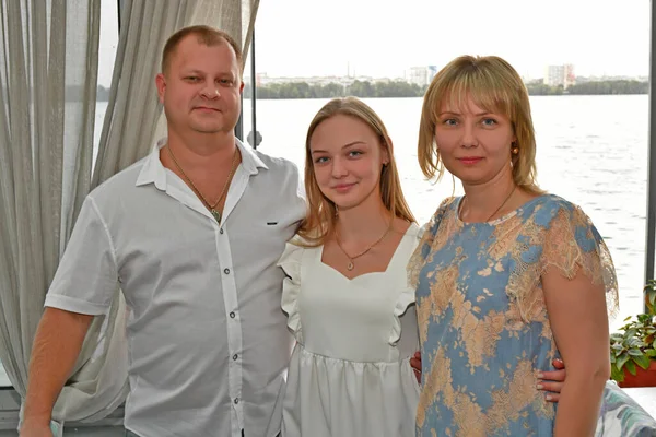 A young family is celebrating a birthday in a restaurant.