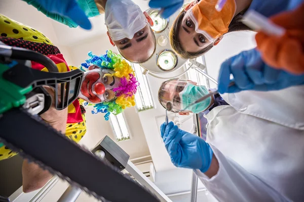 Traumatic dental treatment with scary clown in bottom view — Stock Photo, Image