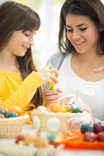 Daughter and mother playful with Easter eggs — Stock Photo, Image