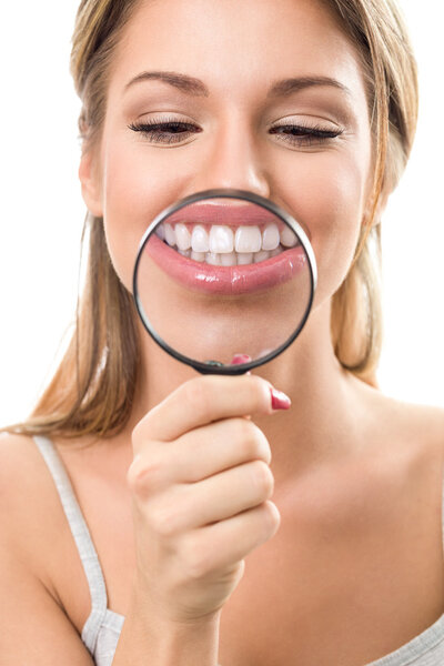 perfect teeth behind magnifying glass