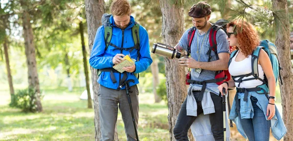 Hikers look at map in break from walkin — Stock Photo, Image