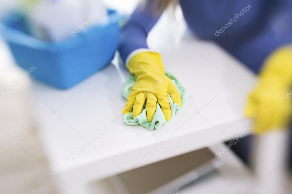 Yellow protecting gloves clears table 