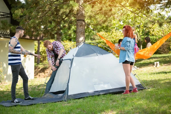Unge mennesker rejser telt i skoven - Stock-foto