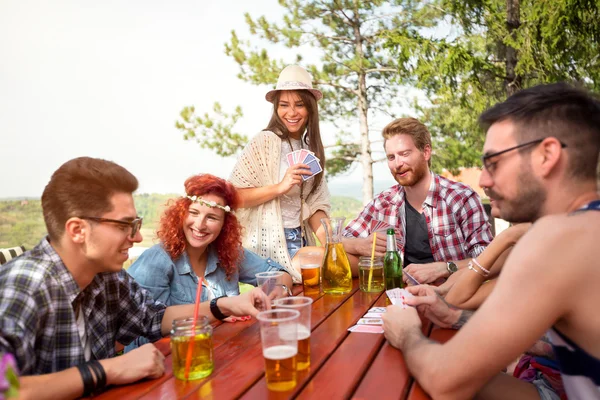 Youth enjoying with friends and card game in forest — Stock Photo, Image