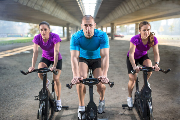people riding exercise bike