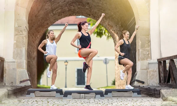 Smiling women stepping training on stepper — Stock Photo, Image