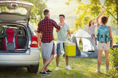 camping trip, Young happy people say hello arrived friends