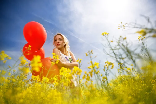 Woman with blue sky in yellow field — Stock Photo, Image