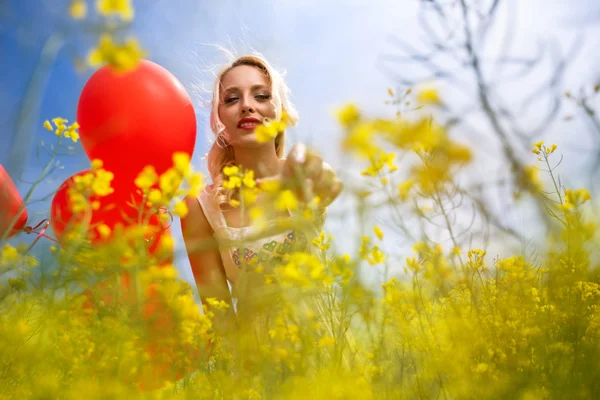 Lovely girl picking flower — Stock Photo, Image