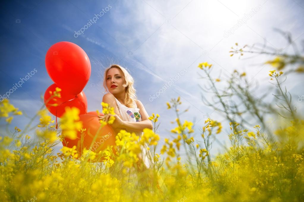woman with blue sky in yellow field