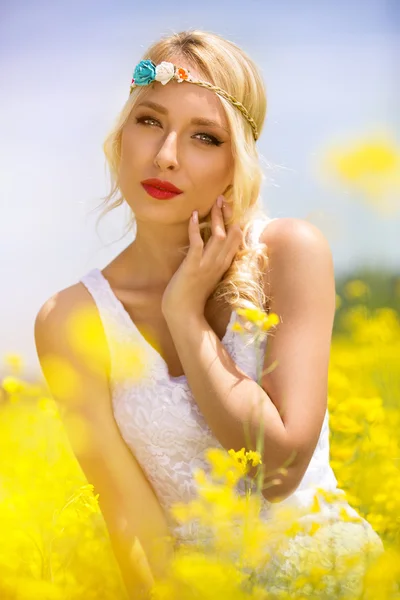 Sensual woman in yellow flowers — Stock Photo, Image